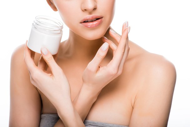 stock-photo-cropped-view-woman-holding-container-while-applying-cosmetic-cream-isolated stock-photo-cropped-view-woman-holding-container-while-applying-cosmetic-cream-isolated